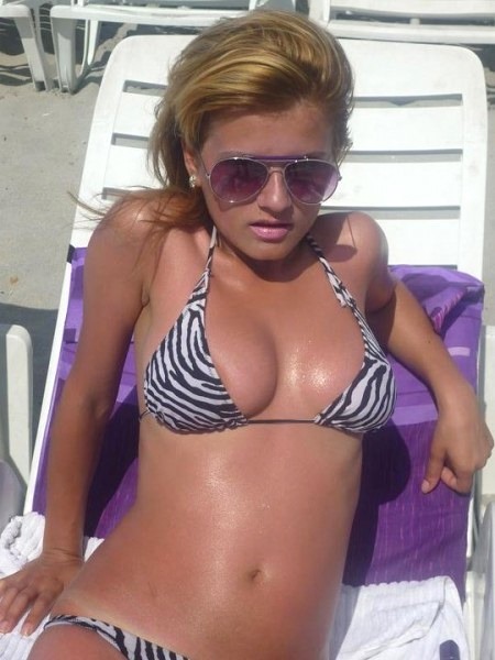 high class cam girl in zebra print bikini at the beach